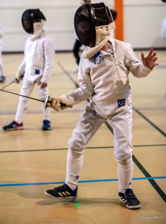 Two fencers engaged in a match.