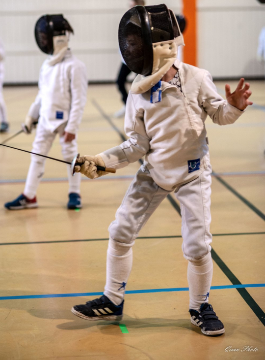 Two fencers engaged in a match.
