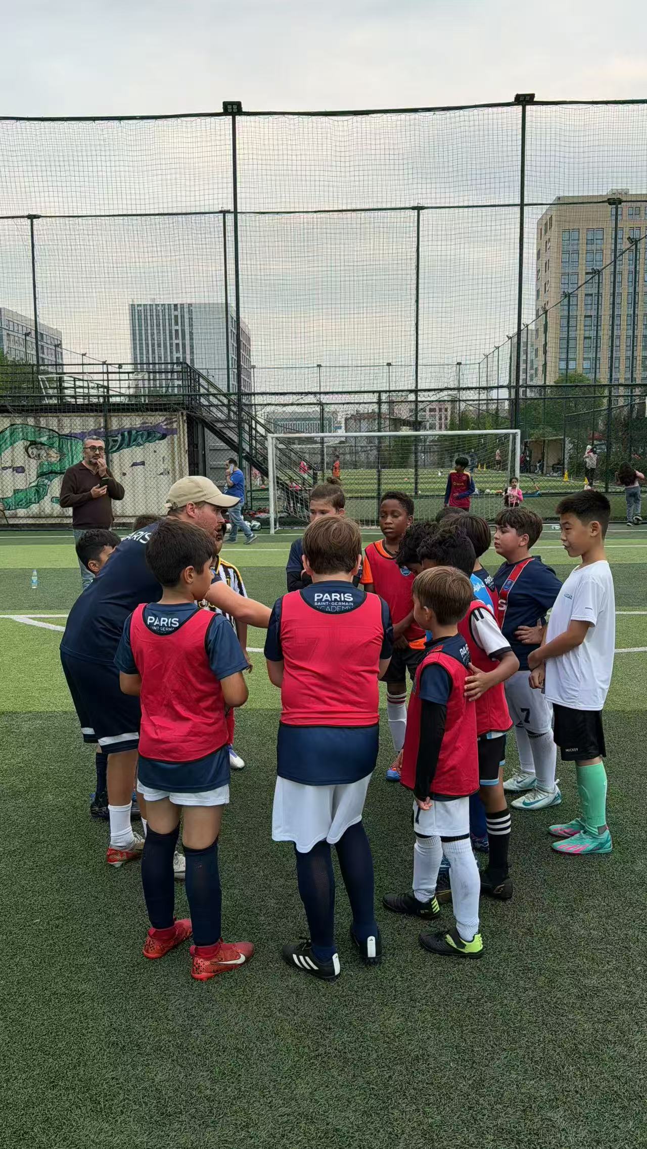 Coach explaining strategy to youth football team.